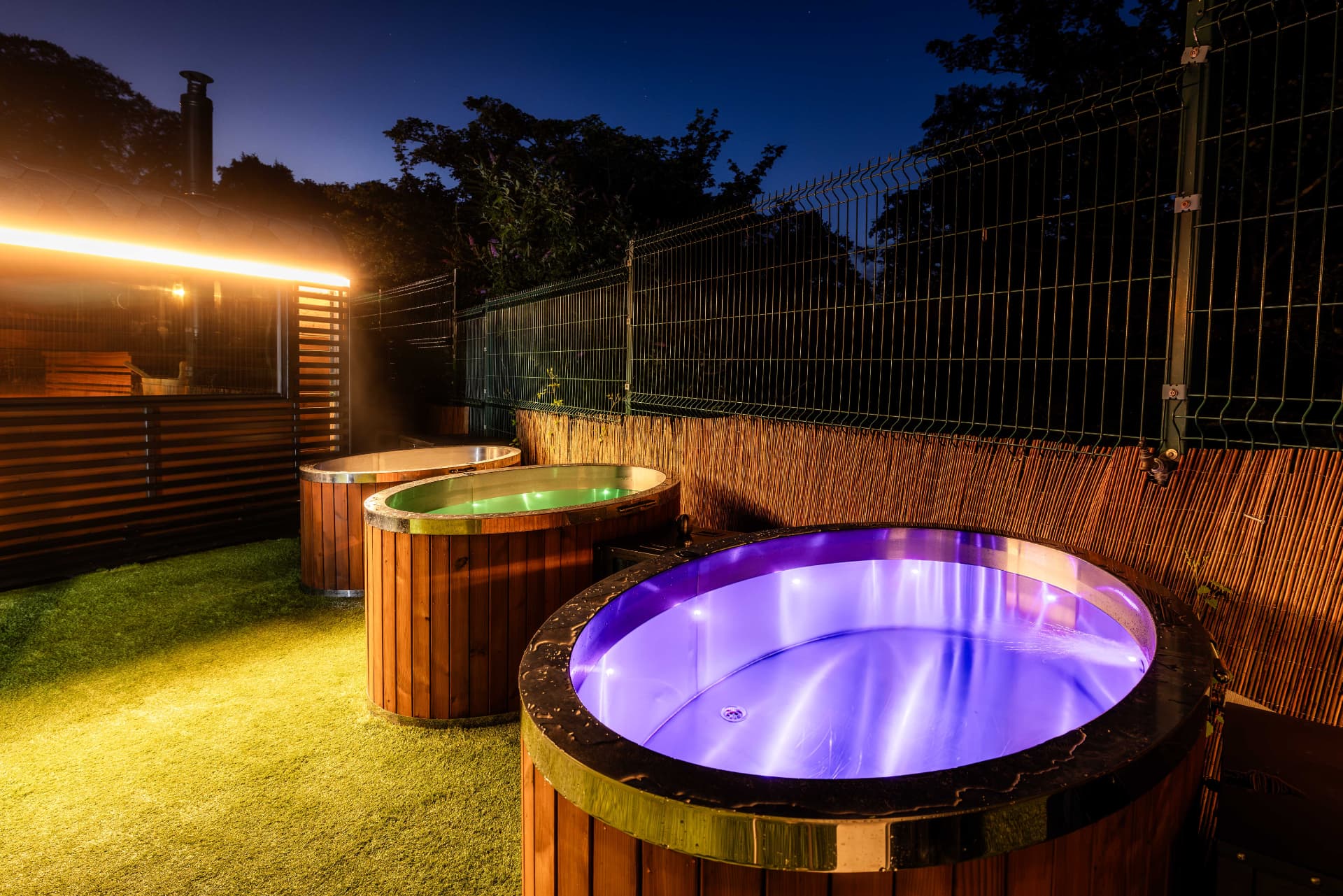 PikeNHot cold plunge pools lit at night